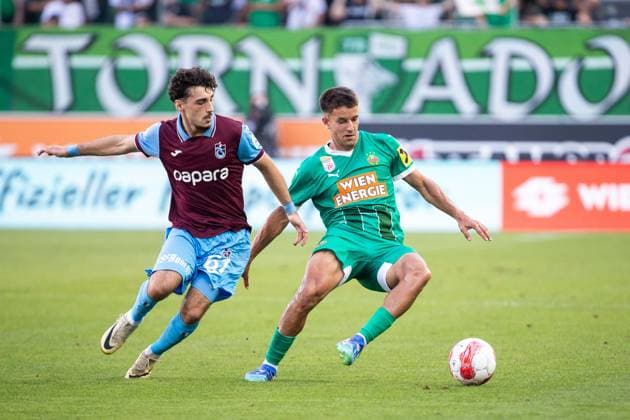 SOCCER - UEFA CL, Rapid vs Trabzonspor VIENNA,AUSTRIA,15.AUG.24 - SOCCER - UEFA Champions League, qualification, SK Rapid Wien vs Trabzonspor Kuluebue. Image shows Cihan Canak (Trabzonspor) and Jonas Auer (Rapid).  GEPAxpictures xPhilippxBrem