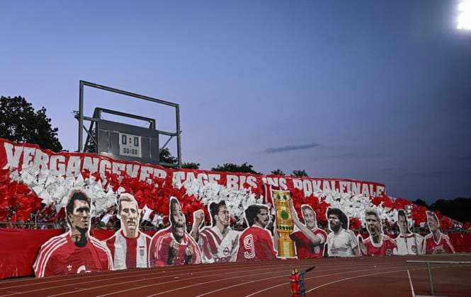 Football DFB Pokal 2024 2025 1 round 16 08 2024 SSV Ulm FC Bayern Muenchen FC Bayern Fan Choreo in the guest block of the Donaustadion Ulm, with pictures of FCB legends Klaus Augenthaler, Hans Georg, Katsche, Schwarzenbeck, Samuel Osei, Sammy, Kuffour, Lothar Matthaeus, Gerd Mueller, Werner Olk with trophy, Paul Breitner, Stefan Effenberg, Franz Beckenbauer and Bastian Schweinsteiger from left to right