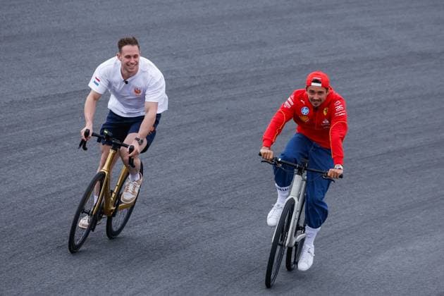 Harry Lavreysen dutch olympic champion track cyclist on his golden bike shows his three golden medals and Charles Leclerc of Monaco and Scuderia Ferrari during previews ahead of the F1 Grand Prix of Netherlands at Circuit Park Zandvoort on August 22, 2024 in Zandvoort, Netherlands Defodi 704 MTB20240822F1ZandvoortDag1352540 Defodi-704