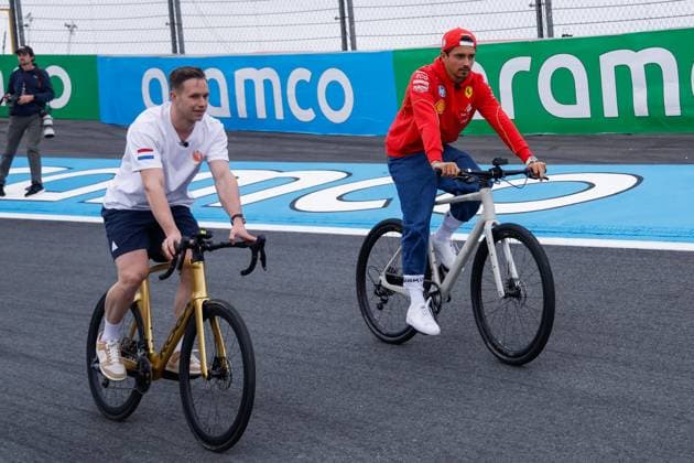 Harry Lavreysen dutch olympic champion track cyclist on his golden bike shows his three golden medals and Charles Leclerc of Monaco and Scuderia Ferrari during previews ahead of the F1 Grand Prix of Netherlands at Circuit Park Zandvoort on August 22, 2024 in Zandvoort, Netherlands Defodi 704 MTB20240822F1ZandvoortDag1352594 Defodi-704