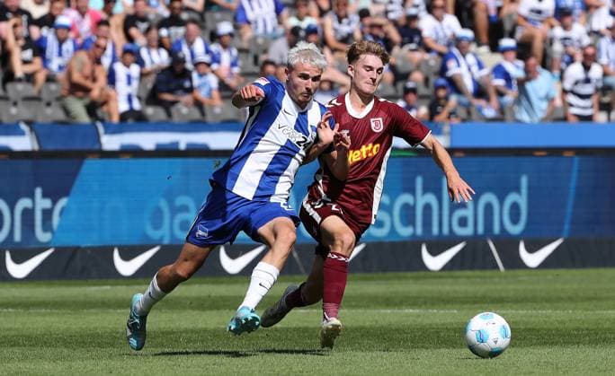 Marten Winkler in a duel with Dominik Kother Match scene Action Sport Football Soccer DFL 2 Bundesliga Men 3 Matchday Season 2024 2025 24 08 2024 Hertha BSC Berlin vs SSV Jahn Regensburg DFL regulations prohibit any use of photographs as image sequences and or quasi video