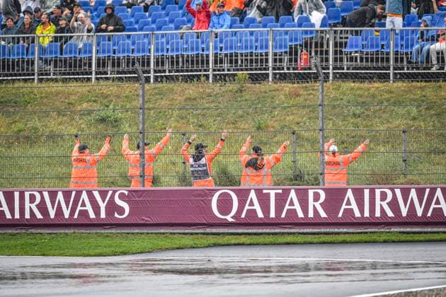 24th August 2024; Circuit Zandvoort, Zandvoort, North Holland, Netherlands; Formula 1 Heineken Dutch Grand Prix 2024; Qualifying Day; Marshals dance in the rain while the session is stopped  ActionPlus12684915 GodfreyxPitt