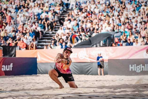 Beach volleyball men Allianz German Beach Tour German Beach Volleyball Championship 2024 01 09 2024 Nejc Zemljak takes the ball Timmendorfer Strand Ahmann Hager Arena Schleswig Holstein Germany