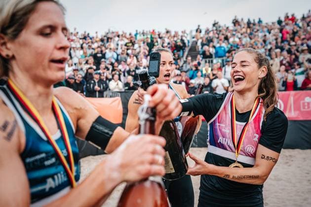 Beach volleyball women and men Allianz German Beach Tour German Beach Volleyball Championship 2024 01 09 2024 from l Louisa Lippmann, Laura Ludwig and Cinja Tillmann Beer shower Timmendorfer Strand Ahmann Hager Arena Schleswig Holstein Germany