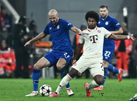 FC Bayern München v GNK Dinamo - UEFA Champions League 2024 25 League Phase MD1 MUNICH, GERMANY - SEPTEMBER 17: Josip Misic of Dinamo Zagreb and Serge Gnabry of Bayern Munich in action during the UEFA Champions League 2024 25 League Phase MD1 match between FC Bayern München and GNK Dinamo at Football Arena Munich on September 17, 2024 in Munich, Germany.  MarkoxLukunic PIXSELL