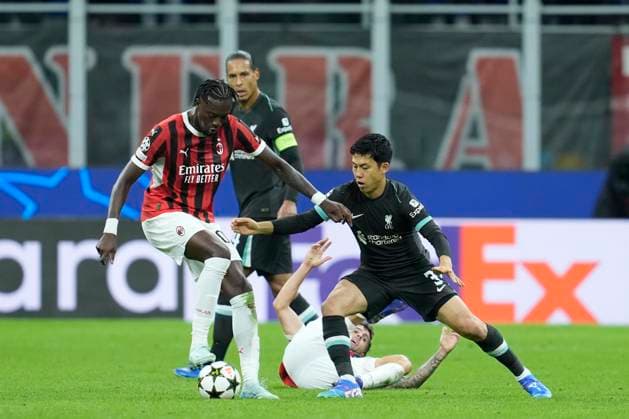 Tammy Abraham (AC Milan) and Wataru Endo (Liverpool FC) battle for the ball, UEFA Champions League 2024 25 League Phase MD1, AC Milan v Liverpool FC, Stadio Giuseppe Meazza (San Siro), September 17, 2024, Milan, Italy.