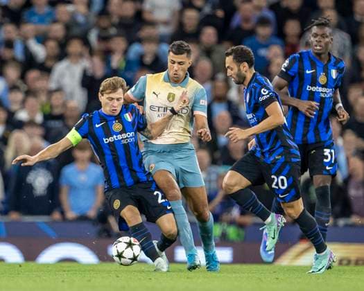 18th September 2024; Etihad Stadium, Manchester, England; UEFA Champions League Football, Manchester City versus Inter Milan; Nicolo Barella of Inter Milan is tackled by Rodri of Manchester City  ActionPlus12694284 TimxWilliams