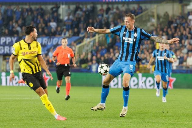 Borussia s Ramy Bensebaini and Club s Gustaf Nilsson fight for the ball during a soccer game between Belgian Club Brugge KV and German Borussia Dortmund, Wednesday 18 September 2024 in Brugge, on the day one of the UEFA Champions League league phase. KURTxDESPLENTER  x100916542x