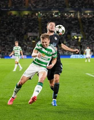 Alistair Johnston of Celtic challenges for the ball with Kevin Wimmer of Slovan Bratislava. Celtic v Slovan Bratislava, UEFA Champions League, Group Stage, Football, Celtic Park, Glasgow, Scotland, UK, 18 Sep 2024 EDITORIAL USE ONLY No use with unauthorised audio, video, data, fixture lists, club league logos or live services. Online in-match use limited to 120 images, no video emulation. No use in betting, games or single club league player publications.  Copyright: xStuartxWallace Shutterstockx 14722221q