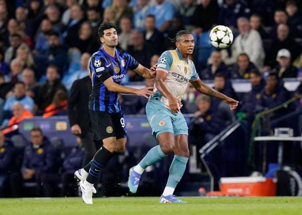 Manchester, England, 18th September 2024. Mehdi Taremi of Inter Milan tussles with Manuel Akanji of Manchester City during the UEFA Champions League match at the Etihad Stadium, Manchester. Picture credit should read: Andrew Yates Sportimage EDITORIAL USE ONLY. No use with unauthorised audio, video, data, fixture lists, club league logos or live services. Online in-match use limited to 120 images, no video emulation. No use in betting, games or single club league player publications. SPI-3321-0041