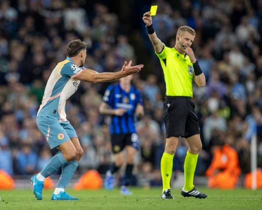 18th September 2024; Etihad Stadium, Manchester, England; UEFA Champions League Football, Manchester City versus Inter Milan; Ruben Dias of Manchester City receives a yellow card  ActionPlus12694313 TimxWilliams