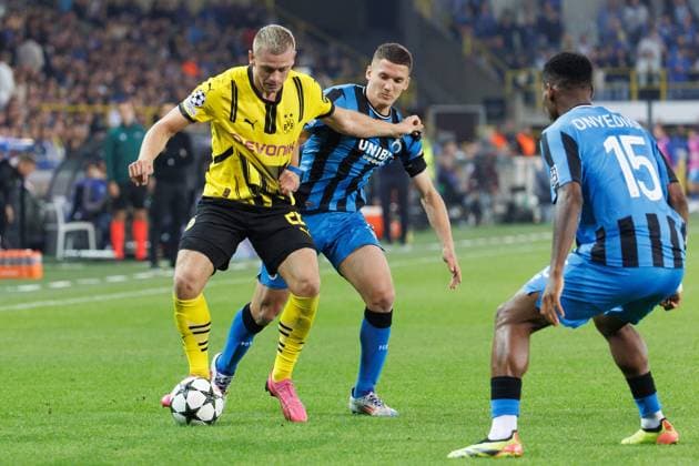 Borussia s Donyell Malen and Club s Christos Tzolis fight for the ball during a soccer game between Belgian Club Brugge KV and German Borussia Dortmund, Wednesday 18 September 2024 in Brugge, on the day one of the UEFA Champions League league phase. KURTxDESPLENTER  x100920287x