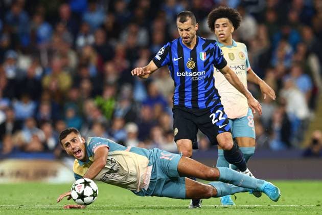 Rodri of Manchester City is challenged by Henrikh Mkhitaryan of Inter Milan Manchester City v Inter Milan, UEFA Champions League, Group Stage, Football, Etihad Stadium, Manchester, UK, 18 Sep 2024 EDITORIAL USE ONLY No use with unauthorised audio, video, data, fixture lists, club league logos or live services. Online in-match use limited to 120 images, no video emulation. No use in betting, games or single club league player publications. Copyright: xMattxWest Shutterstockx 14722162bp