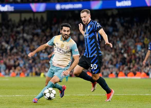Manchester, England, 18th September 2024. Ä°lkay Gundogan of Manchester City gets past Carlos Augusto of Inter Milan during the UEFA Champions League match at the Etihad Stadium, Manchester. Picture credit should read: Andrew Yates Sportimage EDITORIAL USE ONLY. No use with unauthorised audio, video, data, fixture lists, club league logos or live services. Online in-match use limited to 120 images, no video emulation. No use in betting, games or single club league player publications. SPI-3321-0053