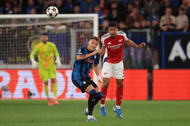 Bergamo, Italy, 19th September 2024. William Saliba of Arsenal FC heads clear from Matteo Retegui of Atalanta during the UEFA Champions League match at Gewiss Stadium, Bergamo. Picture credit should read: Jonathan Moscrop Sportimage EDITORIAL USE ONLY. No use with unauthorised audio, video, data, fixture lists, club league logos or live services. Online in-match use limited to 120 images, no video emulation. No use in betting, games or single club league player publications. SPI-3299-0010