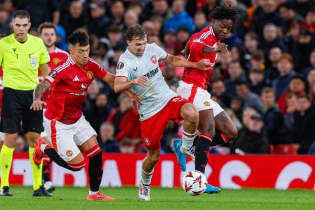 Youri Regeer of FC Twente and Lisandro Martinez of Manchester United, ManU battle for possession , UEFA Europa League 2024 25 League Phase MD1, Manchester United v FC Twente, Old Trafford, September 25, 2024, Manchester, England.