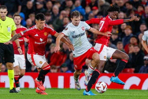 Youri Regeer of FC Twente and Lisandro Martinez of Manchester United, ManU battle for possession , UEFA Europa League 2024 25 League Phase MD1, Manchester United v FC Twente, Old Trafford, September 25, 2024, Manchester, England.