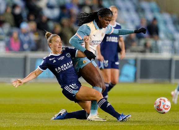Manchester, England, 26th September 2024. Clara Mateo of Paris FC (L) challenges Khadija Shaw of Manchester City during the UEFA Womens Champions League match at the Academy Stadium, Manchester. Picture credit should read: Andrew Yates Sportimage EDITORIAL USE ONLY. No use with unauthorised audio, video, data, fixture lists, club league logos or live services. Online in-match use limited to 120 images, no video emulation. No use in betting, games or single club league player publications. SPI-3335-0005