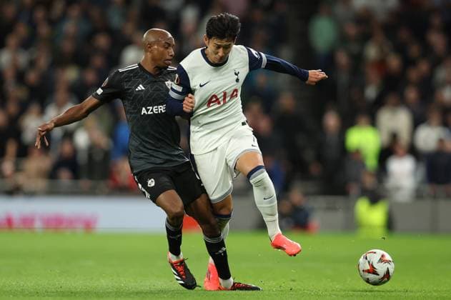 London, England, 26th September 2024. Qarabag™s Julio Romao and Tottenham™s Son Heung-min challenge for the ball during the UEFA Europa League match at the Tottenham Hotspur Stadium, London. Picture credit should read: Paul Terry Sportimage EDITORIAL USE ONLY. No use with unauthorised audio, video, data, fixture lists, club league logos or live services. Online in-match use limited to 120 images, no video emulation. No use in betting, games or single club league player publications. SPI-3334-0062