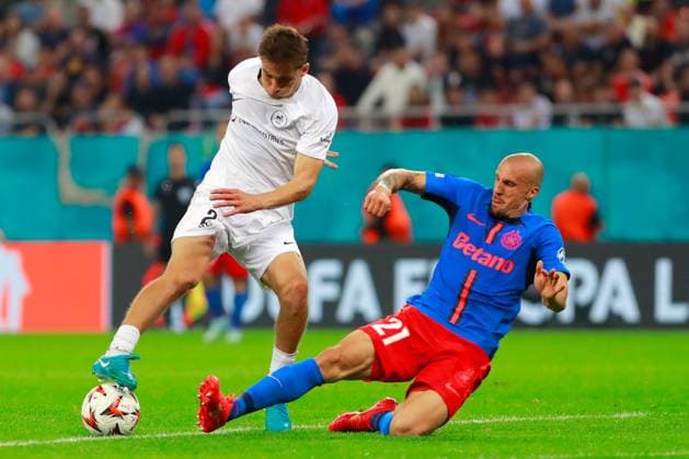 (240927) -- BUCHAREST, Sept. 27, 2024 -- FK RFS s Adam Marhiev (L) vies with FCSB s Vlad Chiriches during a UEFA Europa League match between FCSB and FK RFS in Bucharest, Romania, Sept. 26, 2024. (Photo by Xinhua) (SP)ROMANIA-BUCHAREST-UEFA EUROPA LEAGUE-FCSB VS FK RFS CristianxCristel 