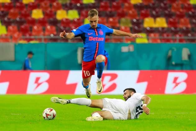 (240927) -- BUCHAREST, Sept. 27, 2024 -- FCSB s Mihai Lixandru (top) vies with FK RFS s Stefan Panic during a UEFA Europa League match between FCSB and FK RFS in Bucharest, Romania, Sept. 26, 2024. (Photo by Xinhua) (SP)ROMANIA-BUCHAREST-UEFA EUROPA LEAGUE-FCSB VS FK RFS CristianxCristel 