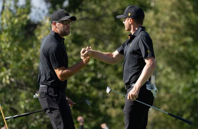 September 27, 2024, Montreal, Pq, CANADA: International team members Mackenzie Hughes of Canada, right and partner Corey Conners of Canada, celebrate their birdie on the eighth hole of their second round foursome match at the Presidents Cup golf tournament at the Royal Montreal Golf Club, in Montreal, Friday, Sept. 27, 2024. Canada News - September 27, 2024 - ZUMAc35_ 20240927_zaf_c35_132 Copyright: xChristinnexMuschix