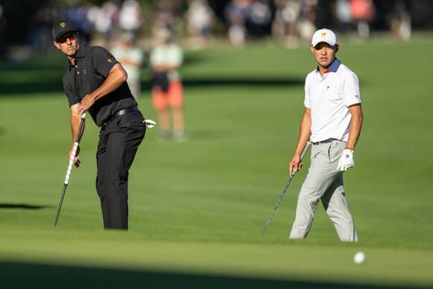 MONTREAL, QC - SEPTEMBER 27: International Team golfer Adam Scott on the 14th green and Team USA golfer Collin Morikawa at the 2024 Presidents Cup on September 27, 2024 at The Royal Montreal Golf Club in Montreal, QC (Photo by Vincent Ethier Icon Sportswire) GOLF: SEP 27 Presidents Cup EDITORIAL USE ONLY Icon2409273512