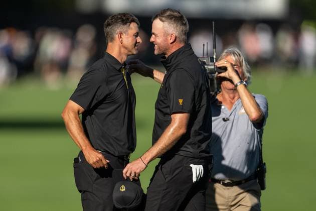 MONTREAL, QC - SEPTEMBER 27: International Team golfer Adam Scott and teammate Taylor Pendrith celebrate on the 14th green at the 2024 Presidents Cup on September 27, 2024 at The Royal Montreal Golf Club in Montreal, QC (Photo by Vincent Ethier Icon Sportswire) GOLF: SEP 27 Presidents Cup EDITORIAL USE ONLY Icon2409273727