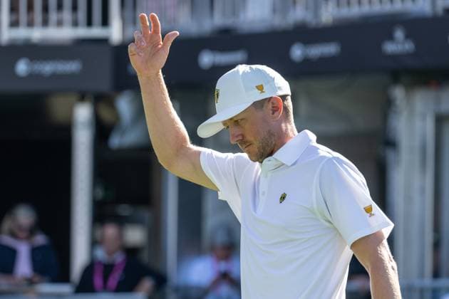 MONTREAL, QC - SEPTEMBER 28: International Team golfer Mackenzie Hughes salutes the crowd at the first tee at the 2024 Presidents Cup on September 28, 2024 at The Royal Montreal Golf Club in Montreal, QC (Photo by Vincent Ethier Icon Sportswire) GOLF: SEP 28 Presidents Cup EDITORIAL USE ONLY Icon2409280386