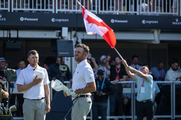 MONTREAL, QC - SEPTEMBER 28: International Team golfer Mackenzie Hughes and teammate Corey Conners during the Canadian national anthem at the first tee at the 2024 Presidents Cup on September 28, 2024 at The Royal Montreal Golf Club in Montreal, QC (Photo by Vincent Ethier Icon Sportswire) GOLF: SEP 28 Presidents Cup EDITORIAL USE ONLY Icon2409280438