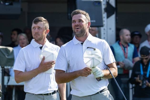 MONTREAL, QC - SEPTEMBER 28: International Team golfer Mackenzie Hughes and teammate Corey Conners during the Canadian national anthem at the first tee at the 2024 Presidents Cup on September 28, 2024 at The Royal Montreal Golf Club in Montreal, QC (Photo by Vincent Ethier Icon Sportswire) GOLF: SEP 28 Presidents Cup EDITORIAL USE ONLY Icon2409280446