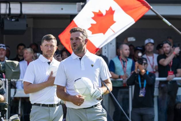 MONTREAL, QC - SEPTEMBER 28: IInternational Team golfer Mackenzie Hughes and teammate Corey Conners during the Canadian national anthem at the first tee at the 2024 Presidents Cup on September 28, 2024 at The Royal Montreal Golf Club in Montreal, QC (Photo by Vincent Ethier Icon Sportswire) GOLF: SEP 28 Presidents Cup EDITORIAL USE ONLY Icon2409280482