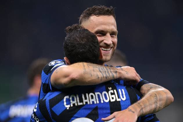 Milan, Italy, 1st October 2024. Hakan Calhanoglu of FC Internazionale celebrates with team mate Marko Arnautovic after scoring to give the side a 1-0 lead during the UEFA Champions League match at Giuseppe Meazza, Milan. Picture credit should read: Jonathan Moscrop Sportimage EDITORIAL USE ONLY. No use with unauthorised audio, video, data, fixture lists, club league logos or live services. Online in-match use limited to 120 images, no video emulation. No use in betting, games or single club league player publications. SPI-3339-0013