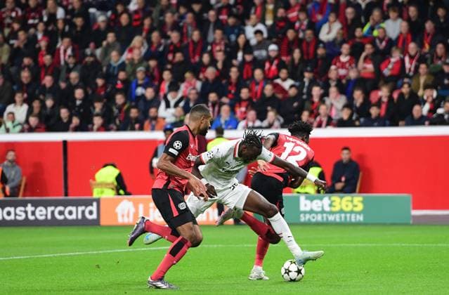 01 10 2024 Leverkusen Football, Men, UEFA Champions League,Matchday 2, Season 2024 2025, Bayer 04 Leverkusen vs AC Milan Tammy Abraham Milan, center tries to assert himself against Jonathan Tah Leverkusen, left and Edmond Tapsoba Leverkusen, right DFL regulations prohibit any use of photographs as image sequences and or quasi video BayArena NRW Germany