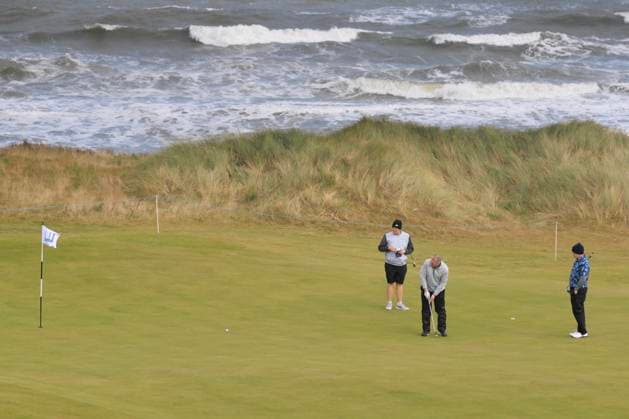 1st October 2024; Kingsbarns Golf Links, Fife, Scotland; Alfred Dunhill Links Golf Championship, Second Practice Day; Robert Macintyre of Scotland watches his father Dougie putt on the third green on Kingsbarns Golf Links, during a practice round ahead of the Dunhill Links Championship  ActionPlus12698757 DavidxYoung
