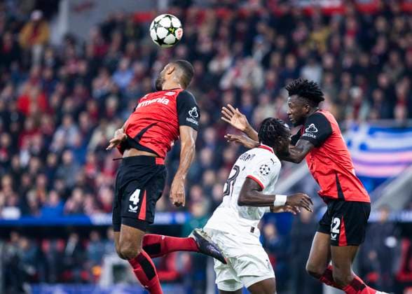 Leverkusen, Bayarena, 01 10 2024 Jonathan Tah of Leverkusen L jumps for a header against Tammy Abraham of Milan during Champions League match Bayer 04 Leverkusen vs AC Milan