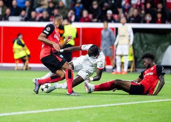 Leverkusen, Bayarena, 01 10 2024 Jonathan Tah of Leverkusen L and Edmond Tapsoba of Leverkusen challenge Tammy Abraham of Milan during Champions League match Bayer 04 Leverkusen vs AC Milan