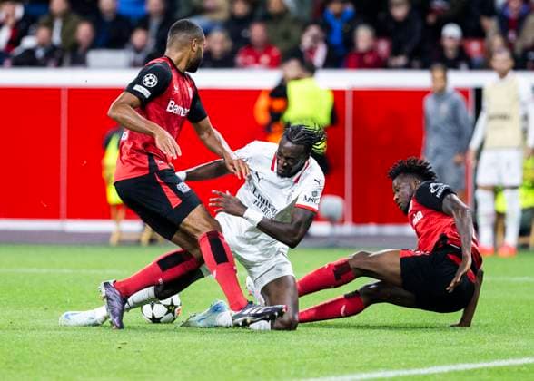 Leverkusen, Bayarena, 01 10 2024 Jonathan Tah of Leverkusen L and Edmond Tapsoba of Leverkusen challenge Tammy Abraham of Milan during Champions League match Bayer 04 Leverkusen vs AC Milan