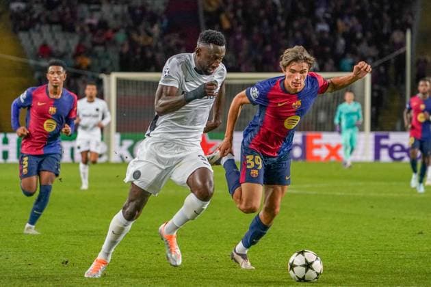 Football UEFA Champions League 2024 2025, Matchday 2 FC Barcelona vs BSC Young Boys Bern Estadi Olimpic Lluis Companys Barcelona Silvere Ganvoula BSC Young Boys, 35 with Andres Cuenca FC Barcelona 39 Barcelona Estadi Olimpic Lluis Companys Spain Copyright: xJOERANxSTEINSIEKx