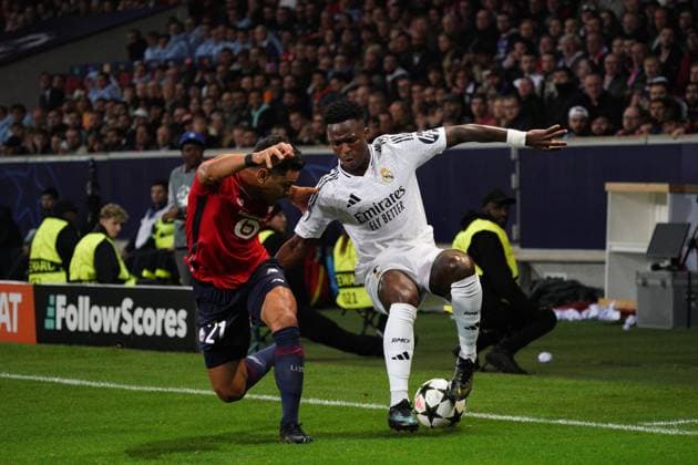 Vinicius Junior of Real Madrid takes on Benjamin Andre of Lille Lille v Real Madrid, UEFA Champions League, Group Stage, Football, Pierre Mauroy Stadium, Lille, France, 02 Oct 2024 EDITORIAL USE ONLY No use with unauthorised audio, video, data, fixture lists, club league logos or live services. Online in-match use limited to 120 images, no video emulation. No use in betting, games or single club league player publications. Copyright: xDavexWinter Shutterstockx 14750773al