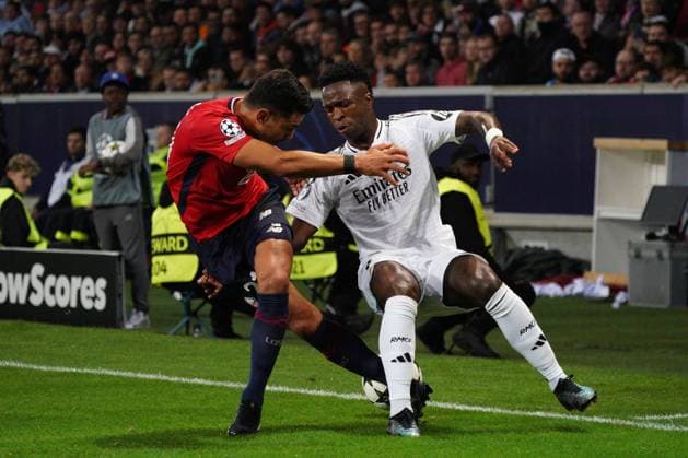 Vinicius Junior of Real Madrid takes on Benjamin Andre of Lille Lille v Real Madrid, UEFA Champions League, Group Stage, Football, Pierre Mauroy Stadium, Lille, France, 02 Oct 2024 EDITORIAL USE ONLY No use with unauthorised audio, video, data, fixture lists, club league logos or live services. Online in-match use limited to 120 images, no video emulation. No use in betting, games or single club league player publications. Copyright: xDavexWinter Shutterstockx 14750773am