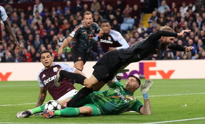 Birmingham, England, 2nd October 2024. Konrad Laimer of Bayern Munich is challenged by Emiliano Martinez of Aston Villa during the UEFA Champions League match at Villa Park, Birmingham. Picture credit should read: Cameron Smith Sportimage EDITORIAL USE ONLY. No use with unauthorised audio, video, data, fixture lists, club league logos or live services. Online in-match use limited to 120 images, no video emulation. No use in betting, games or single club league player publications. SPI-3354-0047