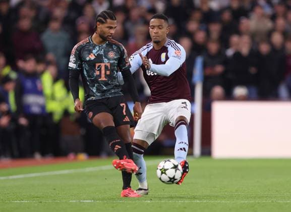 Birmingham, England, 2nd October 2024. Serge Gnabry of Bayern Munich and Ezri Konsa of Aston Villa challenge for the ball during the UEFA Champions League match at Villa Park, Birmingham. Picture credit should read: Cameron Smith Sportimage EDITORIAL USE ONLY. No use with unauthorised audio, video, data, fixture lists, club league logos or live services. Online in-match use limited to 120 images, no video emulation. No use in betting, games or single club league player publications. SPI-3354-0051