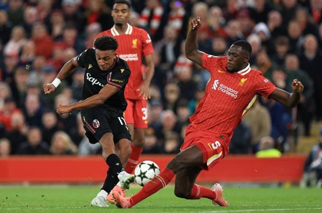 Liverpool, England, 2nd October 2024. Dan Ndoye of Bologna has his shot blocked by Ibrahima KonatÃ of Liverpool during the UEFA Champions League match at Anfield, Liverpool. Picture credit should read: Jessica Hornby Sportimage EDITORIAL USE ONLY. No use with unauthorised audio, video, data, fixture lists, club league logos or live services. Online in-match use limited to 120 images, no video emulation. No use in betting, games or single club league player publications. SPI-3353-0035