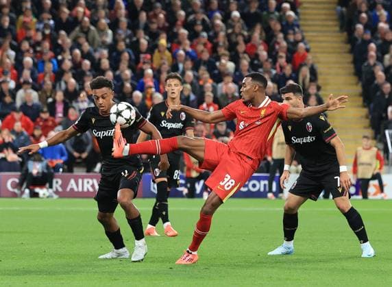 2nd October 2024; Anfield, Liverpool, Merseyside, England; Champions League Football, Liverpool versus Bologna; Trent Alexander-Arnold of Liverpool challenges Dan Ndoye of Bologna for the ball  ActionPlus12699200 DavidxBlunsden
