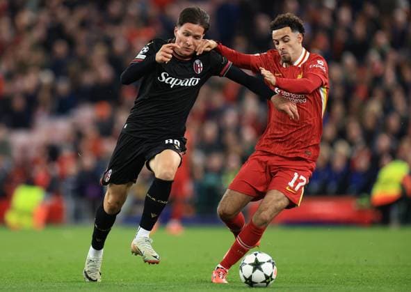 Liverpool, England, 2nd October 2024. Giovanni Fabbian of Bologna and Curtis Jones of Liverpool challenge for the ball during the UEFA Champions League match at Anfield, Liverpool. Picture credit should read: Jessica Hornby Sportimage EDITORIAL USE ONLY. No use with unauthorised audio, video, data, fixture lists, club league logos or live services. Online in-match use limited to 120 images, no video emulation. No use in betting, games or single club league player publications. SPI-3353-0038