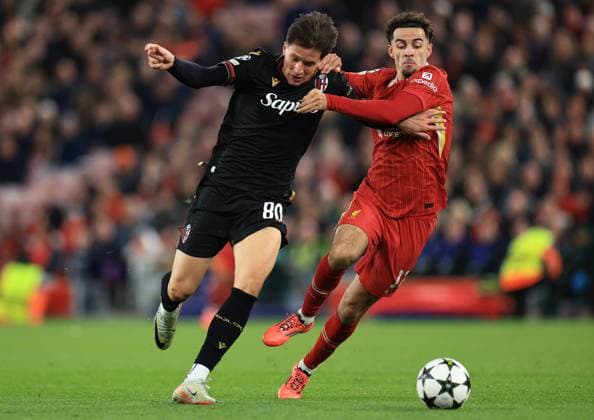 Liverpool, England, 2nd October 2024. Giovanni Fabbian of Bologna and Curtis Jones of Liverpool challenge for the ball during the UEFA Champions League match at Anfield, Liverpool. Picture credit should read: Jessica Hornby Sportimage EDITORIAL USE ONLY. No use with unauthorised audio, video, data, fixture lists, club league logos or live services. Online in-match use limited to 120 images, no video emulation. No use in betting, games or single club league player publications. SPI-3353-0039