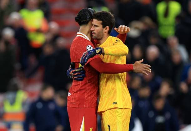 Liverpool, England, 2nd October 2024. Virgil van Dijk and Alisson Becker of Liverpool hug at the end of the UEFA Champions League match at Anfield, Liverpool. Picture credit should read: Jessica Hornby Sportimage EDITORIAL USE ONLY. No use with unauthorised audio, video, data, fixture lists, club league logos or live services. Online in-match use limited to 120 images, no video emulation. No use in betting, games or single club league player publications. SPI-3353-0045
