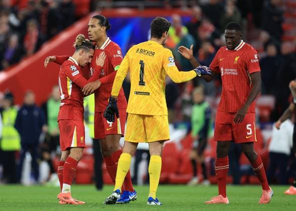 Liverpool, England, 2nd October 2024. (L-R) Kostas Tsimikas, Virgil van Dijk, Alisson Becker and Ibrahima KonatÃ of Liverpool celebrate after the UEFA Champions League match at Anfield, Liverpool. Picture credit should read: Jessica Hornby Sportimage EDITORIAL USE ONLY. No use with unauthorised audio, video, data, fixture lists, club league logos or live services. Online in-match use limited to 120 images, no video emulation. No use in betting, games or single club league player publications. SPI-3353-0046