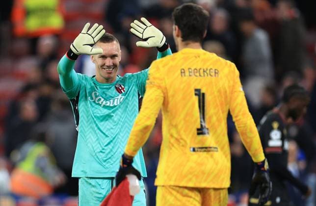 Liverpool, England, 2nd October 2024. Lukasz Skorupski of Bologna and Alisson Becker of Liverpool after the UEFA Champions League match at Anfield, Liverpool. Picture credit should read: Jessica Hornby Sportimage EDITORIAL USE ONLY. No use with unauthorised audio, video, data, fixture lists, club league logos or live services. Online in-match use limited to 120 images, no video emulation. No use in betting, games or single club league player publications. SPI-3353-0047